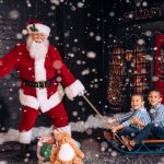 santa pulls brothers on sleigh at santa experience by Gary Evans Photography